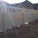 4-foot high tan vinyl privacy fence with baluster top in Highland, Utah