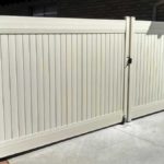Tan vinyl privacy double drive gate with wheel